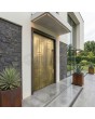 Aluminium hinged entry door with yellow brass texture of milled metal